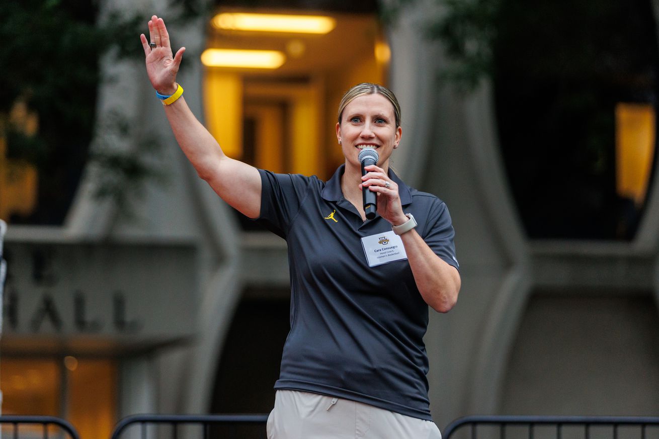 New Marquette women’s basketball head coach Cara Consuegra waves to the crowd at the 2024 Marquette Athletics Block Party.