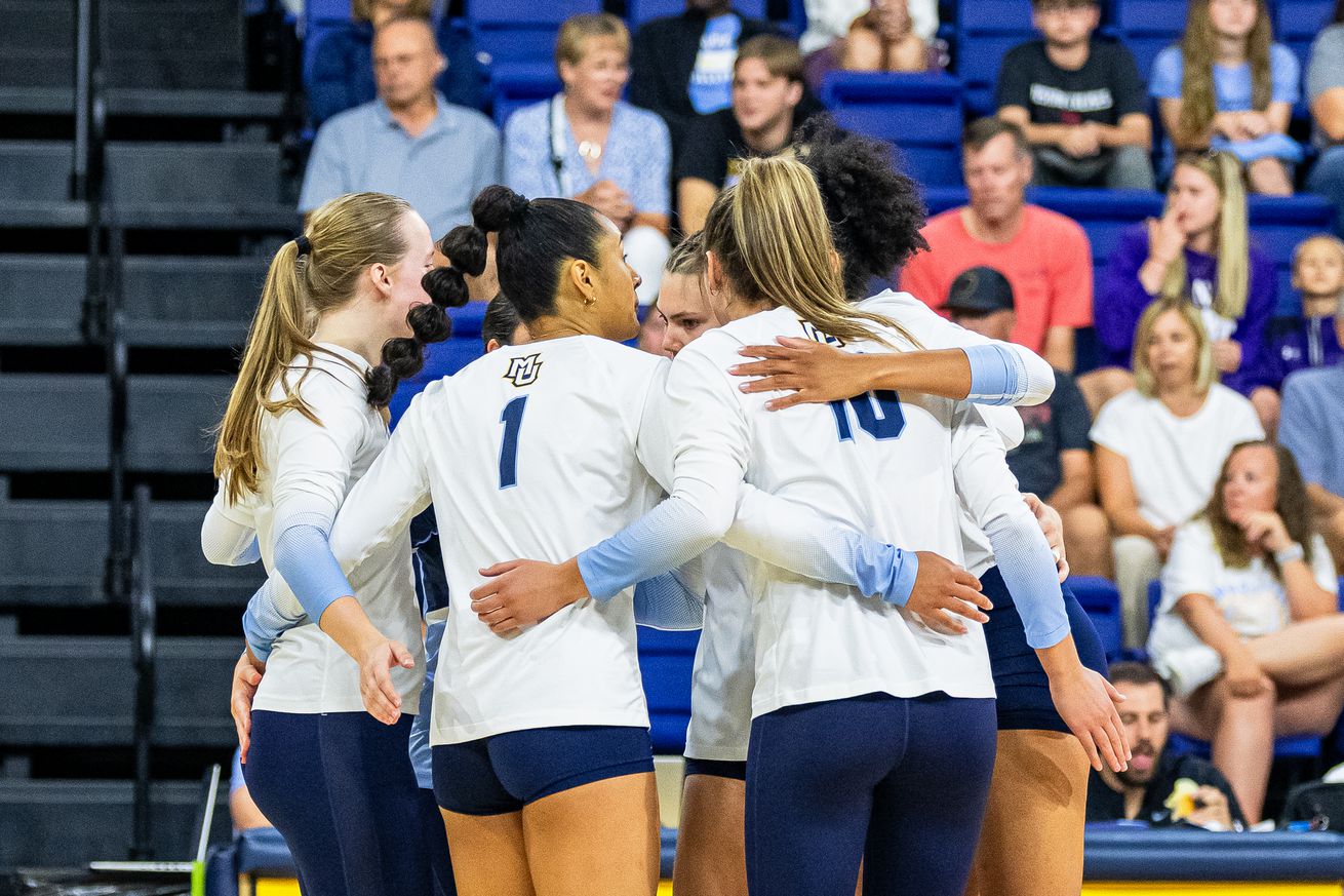 Marquette volleyball huddles during an exhibition match against Northwestern.