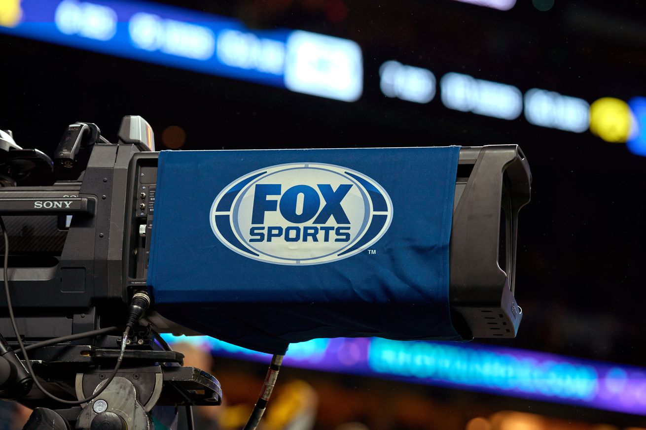 A detail view of a Fox Sports logo is seen on a broadcast tv camera the Big Ten Championship Game between the Iowa Hawkeyes and the Michigan Wolverines on December 04, 2021, at Lucas Oil Stadium, in Indianapolis, IN.