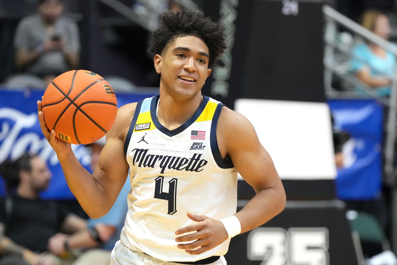 Stevie Mitchell #4 of the Marquette Golden Eagles warms up before a college basketball game against the Kansas Jayhawks on day two of the Allstate Maui Invitational at the SimpliFi Arena at Stan Sheriff Center on November 21, 2023 in Honolulu, Hawaii.