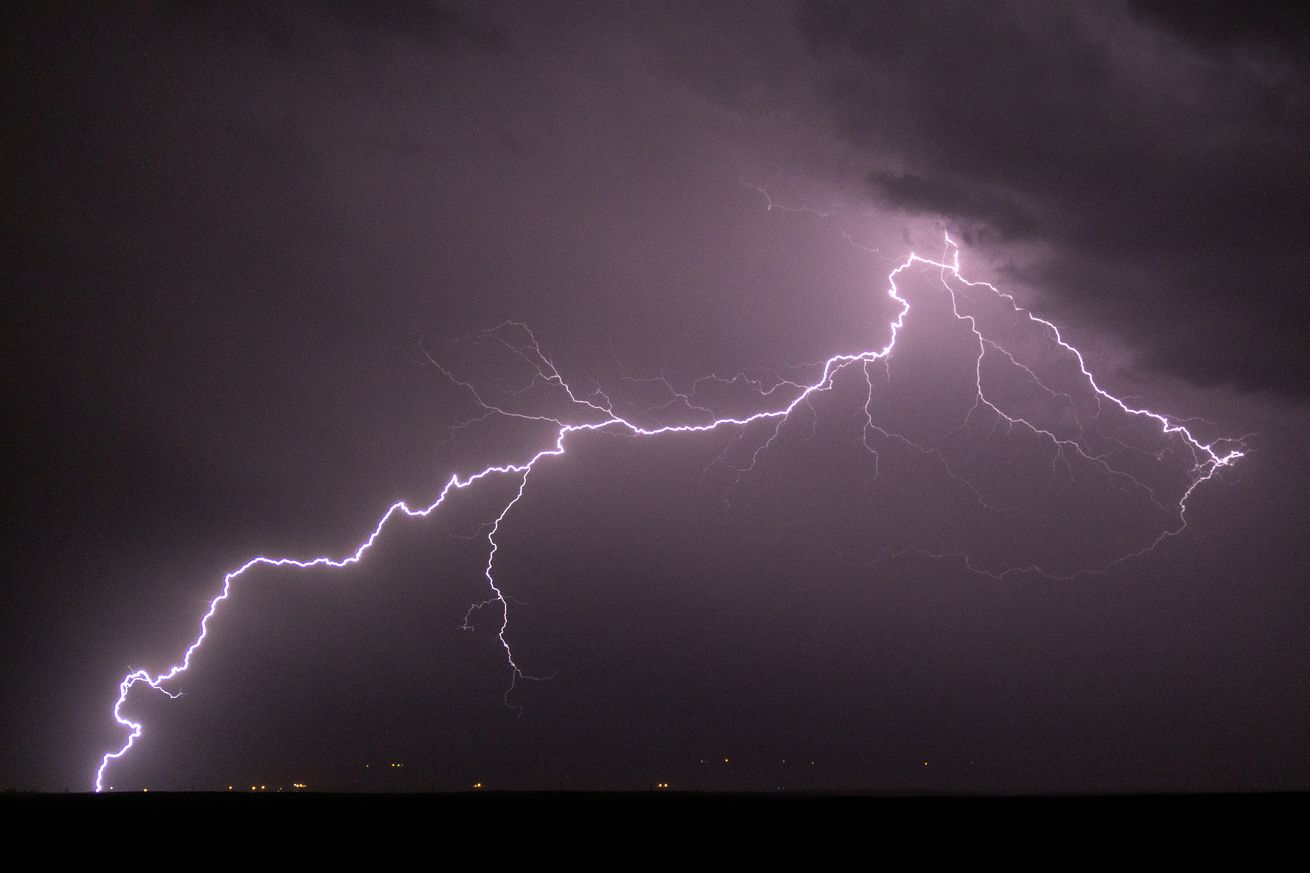 Lightning brightens the night sky as monsoon storms continue to cross the region on August 23, 2024 near Shiprock, New Mexico. A shift in wind direction from westerly to southerly typically triggers the American Southwest monsoon by mid-June and runs through September, bringing storms of often-spectacular cloudbursts that produce widespread flash floods and dangerous lightning.