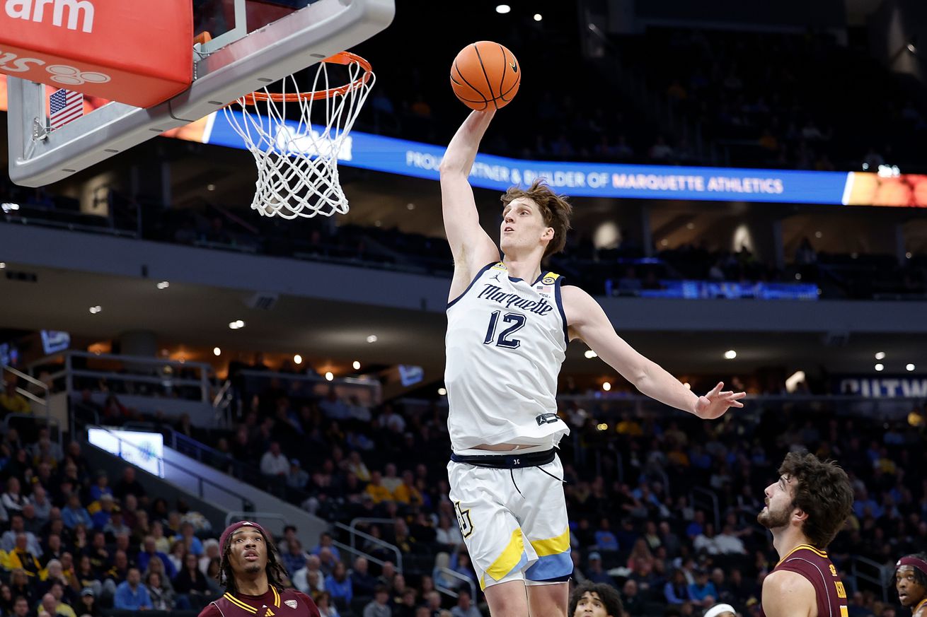 Ben Gold #12 of the Marquette Golden Eagles scores on a slam dunk in the first half of the game against the Central Michigan Chippewas at Fiserv Forum on November 11, 2024 in Milwaukee, Wisconsin.