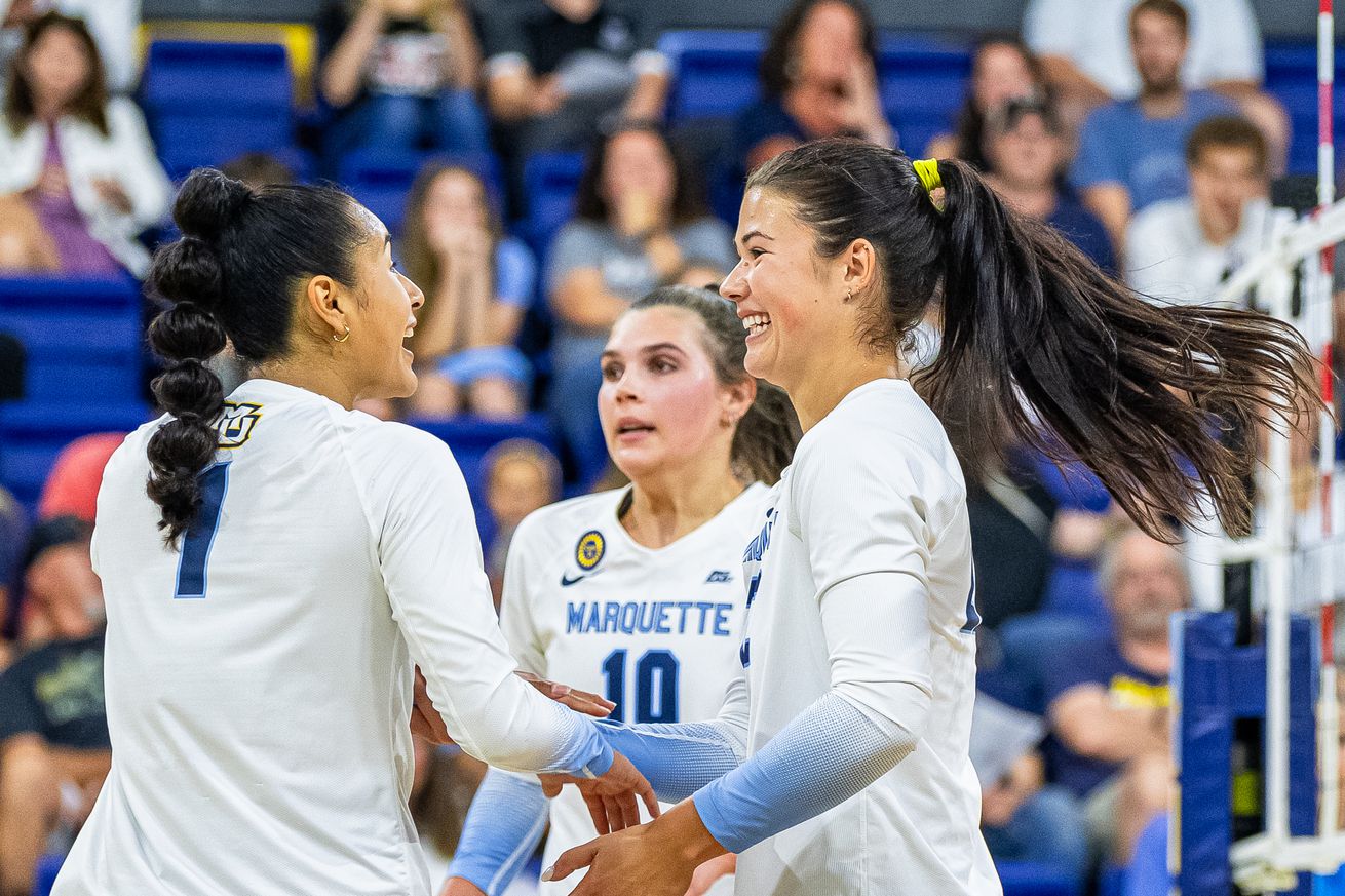 Marquette’s Yadhira Anchante, Aubrey Hamilton, and Hattie Bray, after a point in a volleyball match.