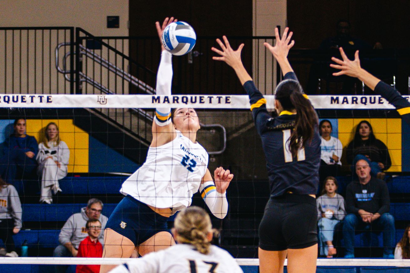 Marquette middle blocker Hattie Bray taking a swing at the net against Milwaukee on October 22, 2024.