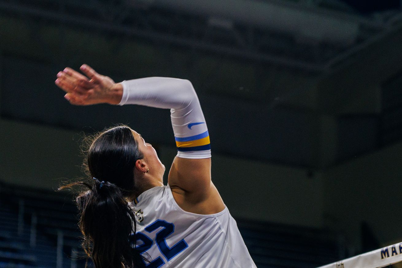 Marquette’s Hattie Bray taking a swing at the net against UConn.