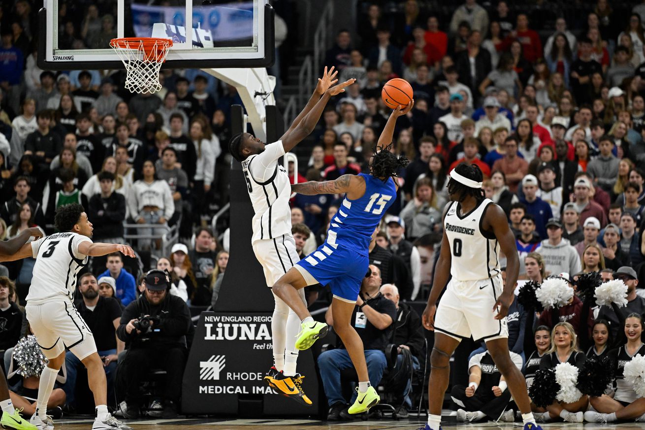 Central Connecticut State Blue Devils forward Jayden Brown (15) shoots over the defense of Providence Friars forward Oswin Erhunmwunse (55) during the first half at Amica Mutual Pavilion. 