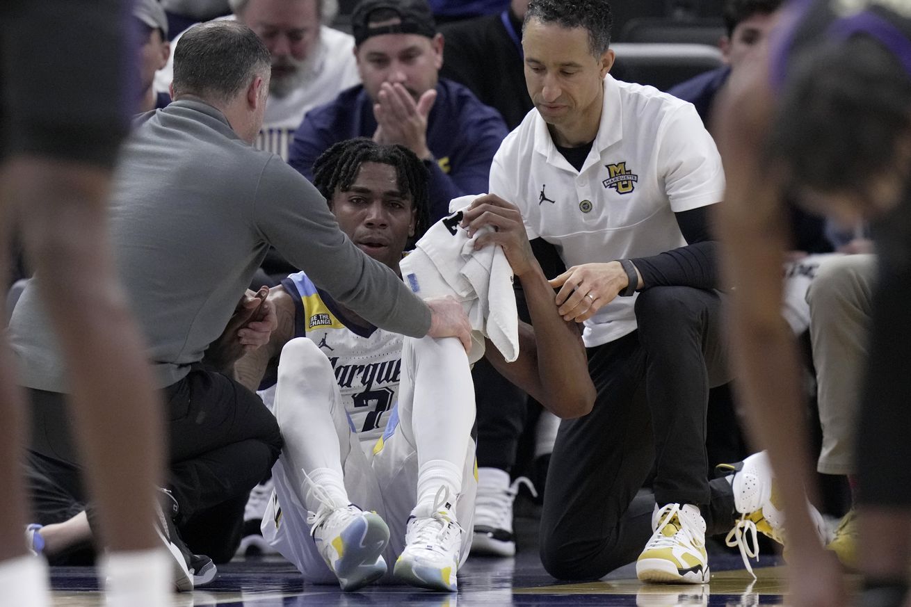 Marquette Golden Eagles guard Zaide Lowery is assisted by head coach Shaka Smart (right) and a trainer after suffering an apparent injury during the second half against the Western Carolina Catamounts at Fiserv Forum. Marquette won 94-62. 