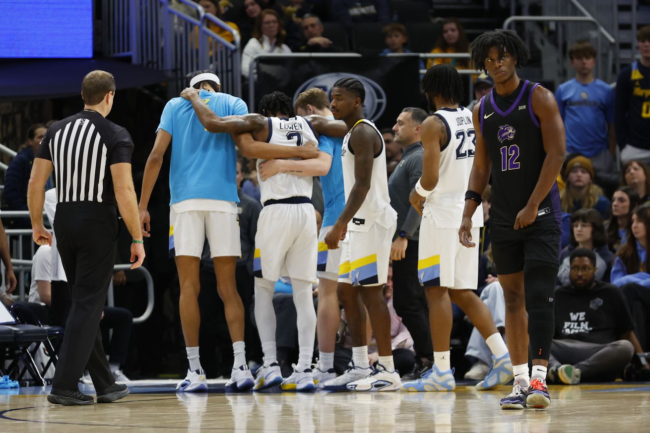 Marquette Golden Eagles guard Zaide Lowery (7) is helped off the court by teammates during a game between the Marquette Golden Eagles and the Western Carolina Catamounts at Fiserv Forum on November 30, 2024 in Milwaukee, WI.