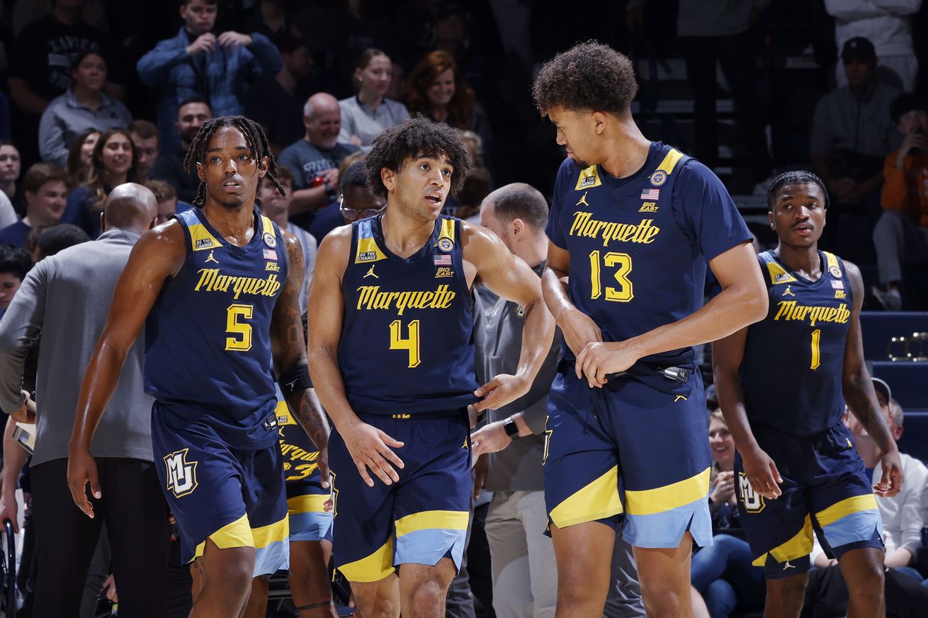 Marquette Golden Eagles forward Royce Parham (13), guard Stevie Mitchell (4) and guard Tre Norman (5) take the floor during a college basketball game against the Xavier Musketeers on December 21, 2024 at Cintas Center in Cincinnati, Ohio.