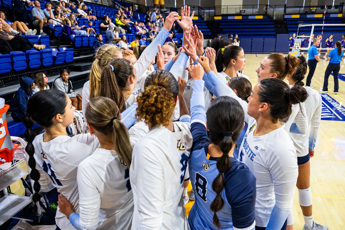 Marquette volleyball huddles up during an exhibition match against Northwestern in 2024.