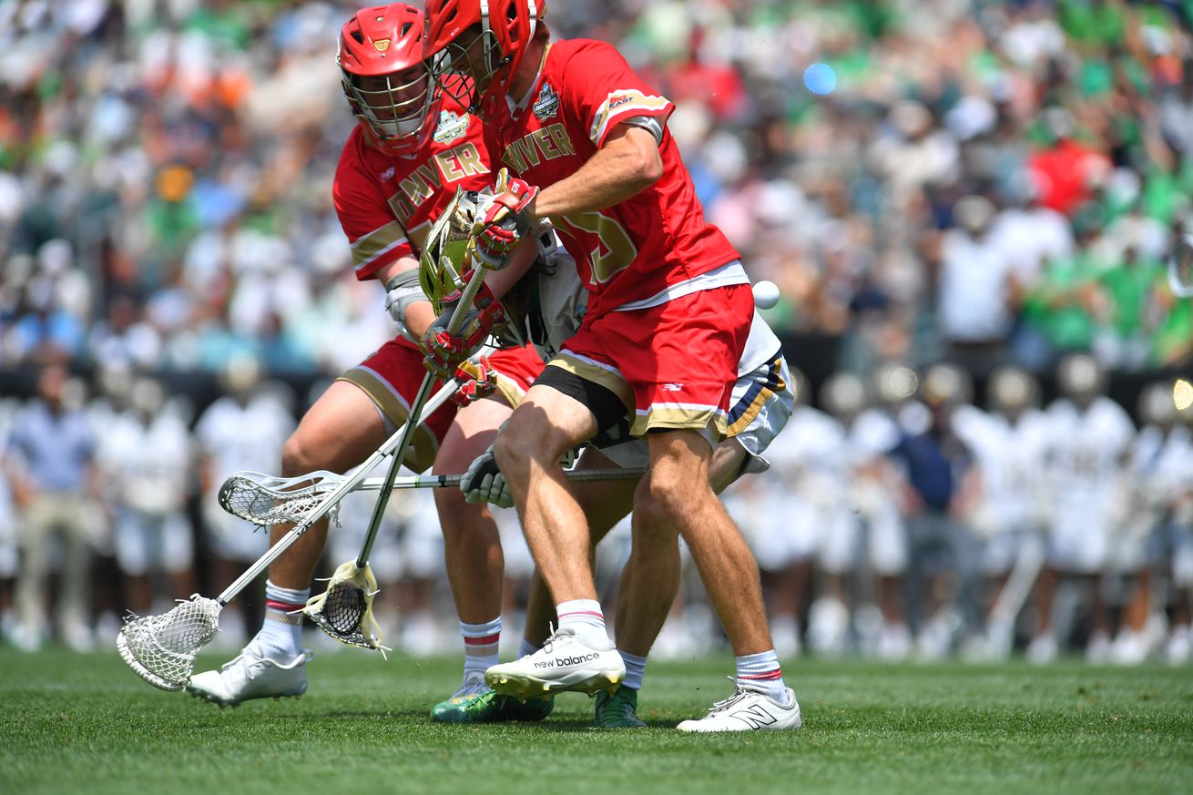 Pat Kavanagh #51 of the Notre Dame Fighting Irish gets sandwiched by AJ Mercurio #16 and Jimmy Freehill #15 of the University of Denver Pioneers during the Division I Men’s Lacrosse Semifinals held at Lincoln Financial Field on May 25, 2024 in Philadelphia, Pennsylvania.