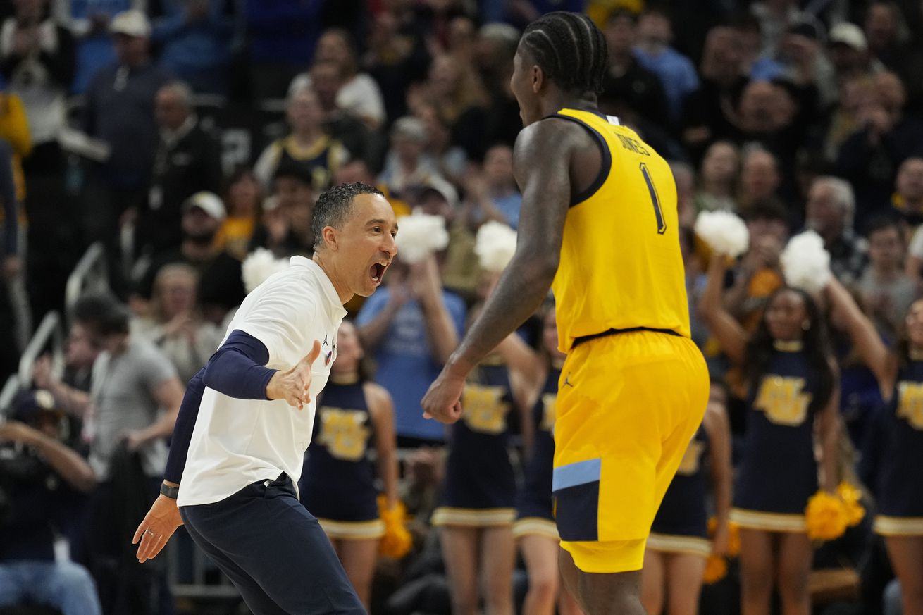 Head coach Shaka Smart of the Marquette Golden Eagles celebrates with Kam Jones #1 during the second half against the Creighton Bluejays at Fiserv Forum on January 03, 2025 in Milwaukee, Wisconsin.