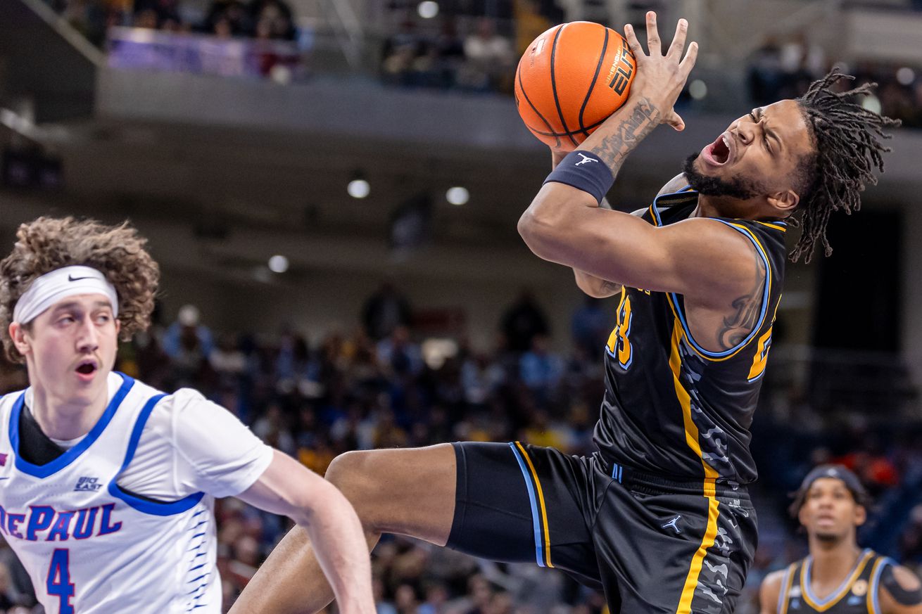 David Joplin #23 of the Marquette Golden Eagles loses the ball after a foul from Conor Enright #4 of the DePaul Blue Demons during the first half at Wintrust Arena on January 14, 2025 in Chicago, Illinois.