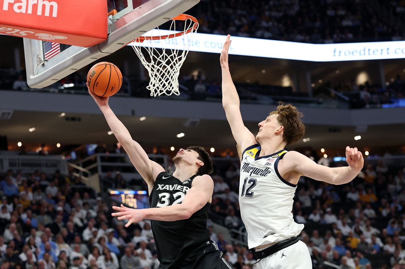 Zach Freemantle #32 of the Xavier Musketeers drives to the basket against Ben Gold #12 of the Marquette Golden Eagles during the second half at Fiserv Forum on January 18, 2025 in Milwaukee, Wisconsin.