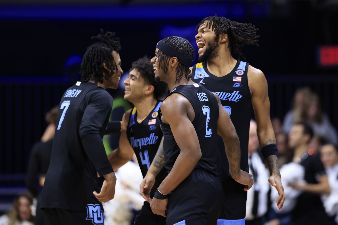 Chase Ross #2, Zaide Lowery #7, Stevie Mitchell #4 and David Joplin #23 of the Marquette Golden Eagles celebrate after a win over the Butler Bulldogs at Hinkle Fieldhouse on January 28, 2025 in Indianapolis, Indiana.