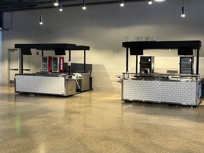 A closed cotton candy concession stand and a closed beverage concession stand at Fiserv Forum.