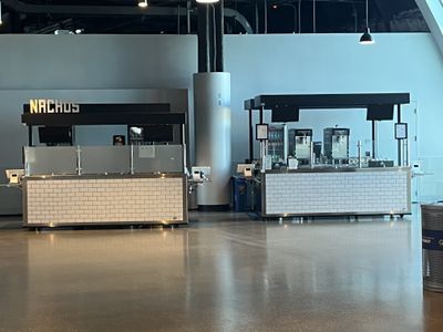 A closed nachos concession cart and a closed Casamigos margarita concession cart at Fiserv Forum.