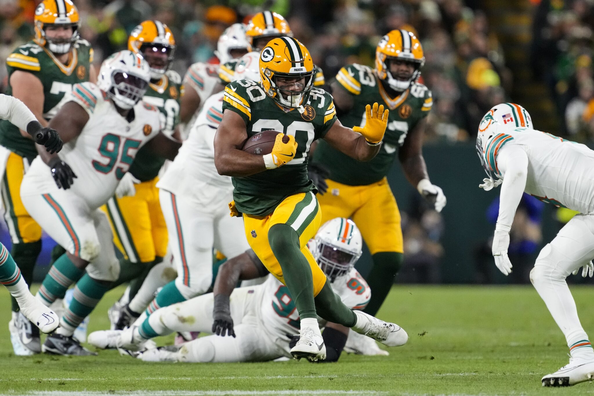 Green Bay Packers running back Chris Brooks (30) rushes with the football during the second quarter against the Miami Dolphins at Lambeau Field.