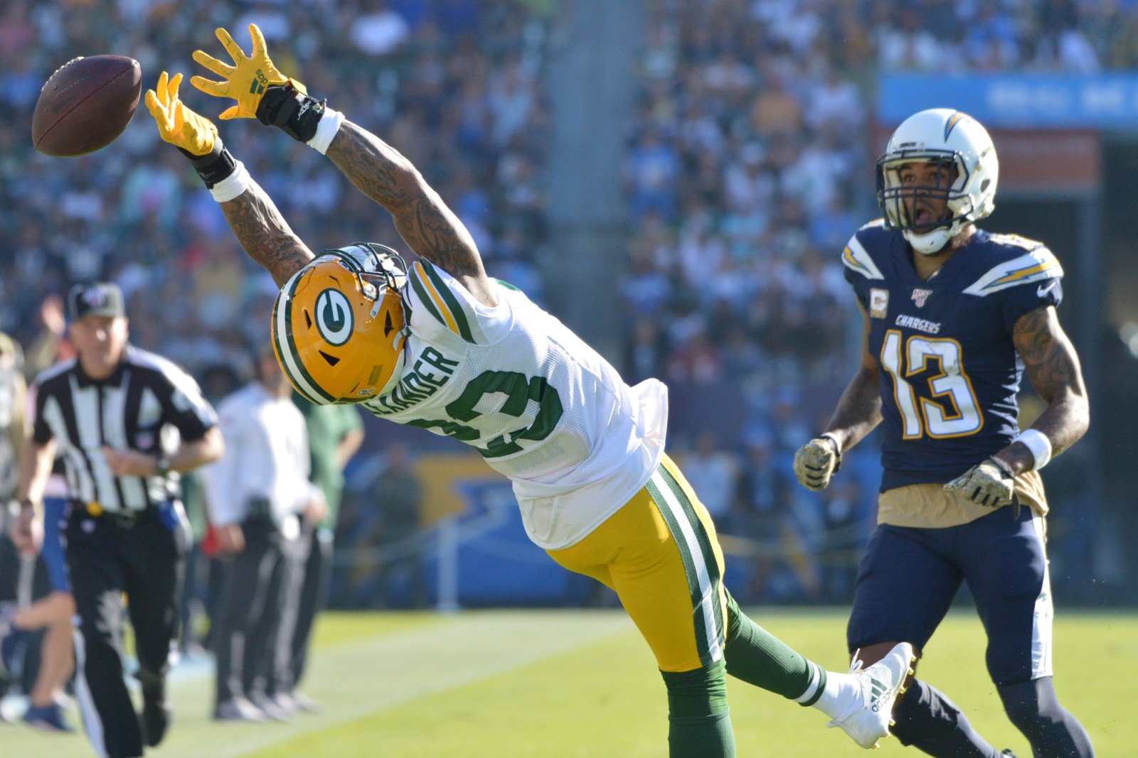 Jaire Alexander reaches for a pass thrown during his defensive coverage