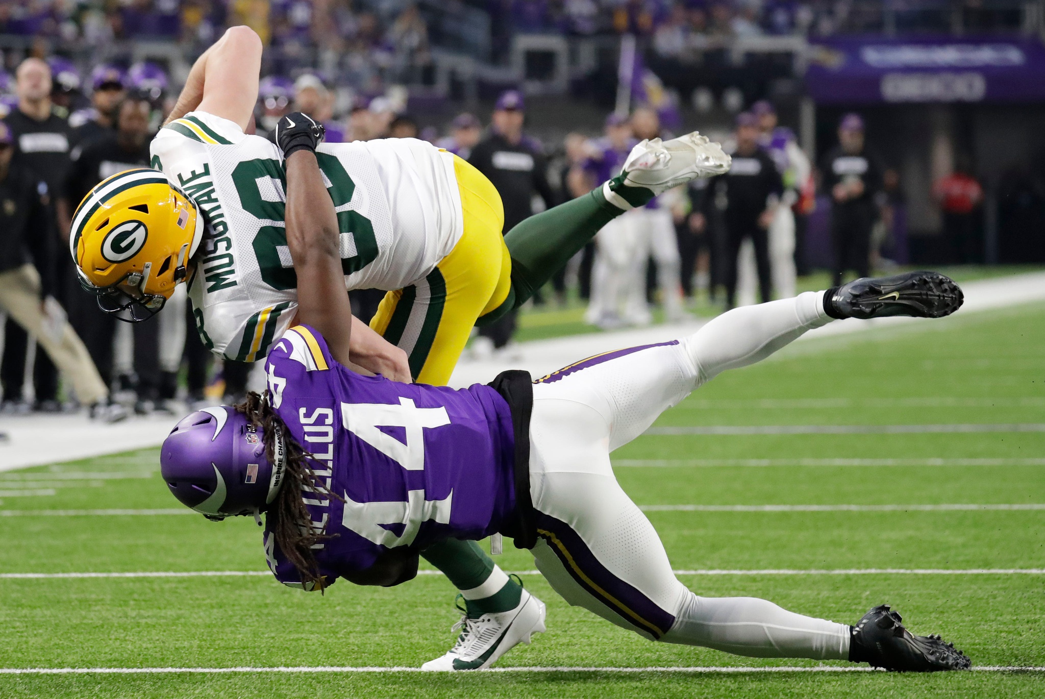 Luke Musgrave (88) is stopped short of a first down by Minnesota Vikings safety Josh Metellus