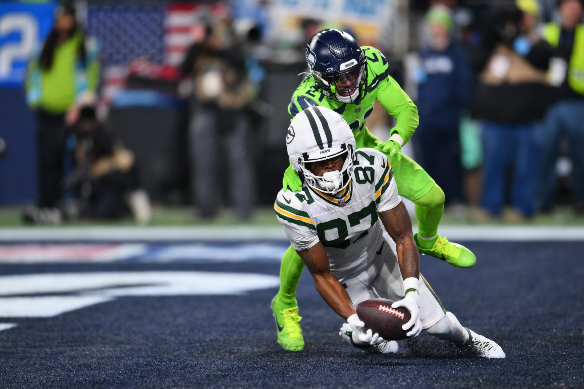 Green Bay Packers wide receiver Romeo Doubs (87) catches a pass for a touchdown while covered by Seattle Seahawks cornerback Devon Witherspoon (21) during the second half at Lumen Field.