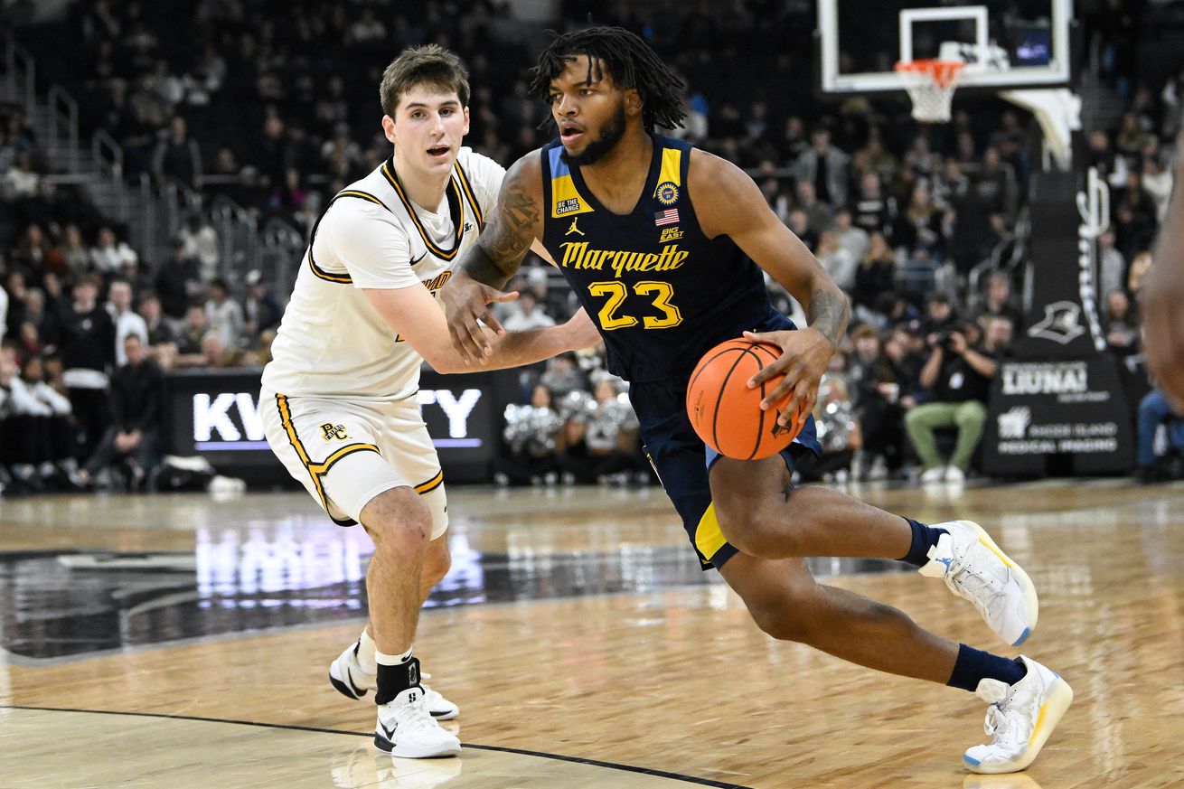 Marquette Golden Eagles forward David Joplin (23) drives to the basket against Providence Friars forward Ryan Mela (11) during the second half at Amica Mutual Pavilion.