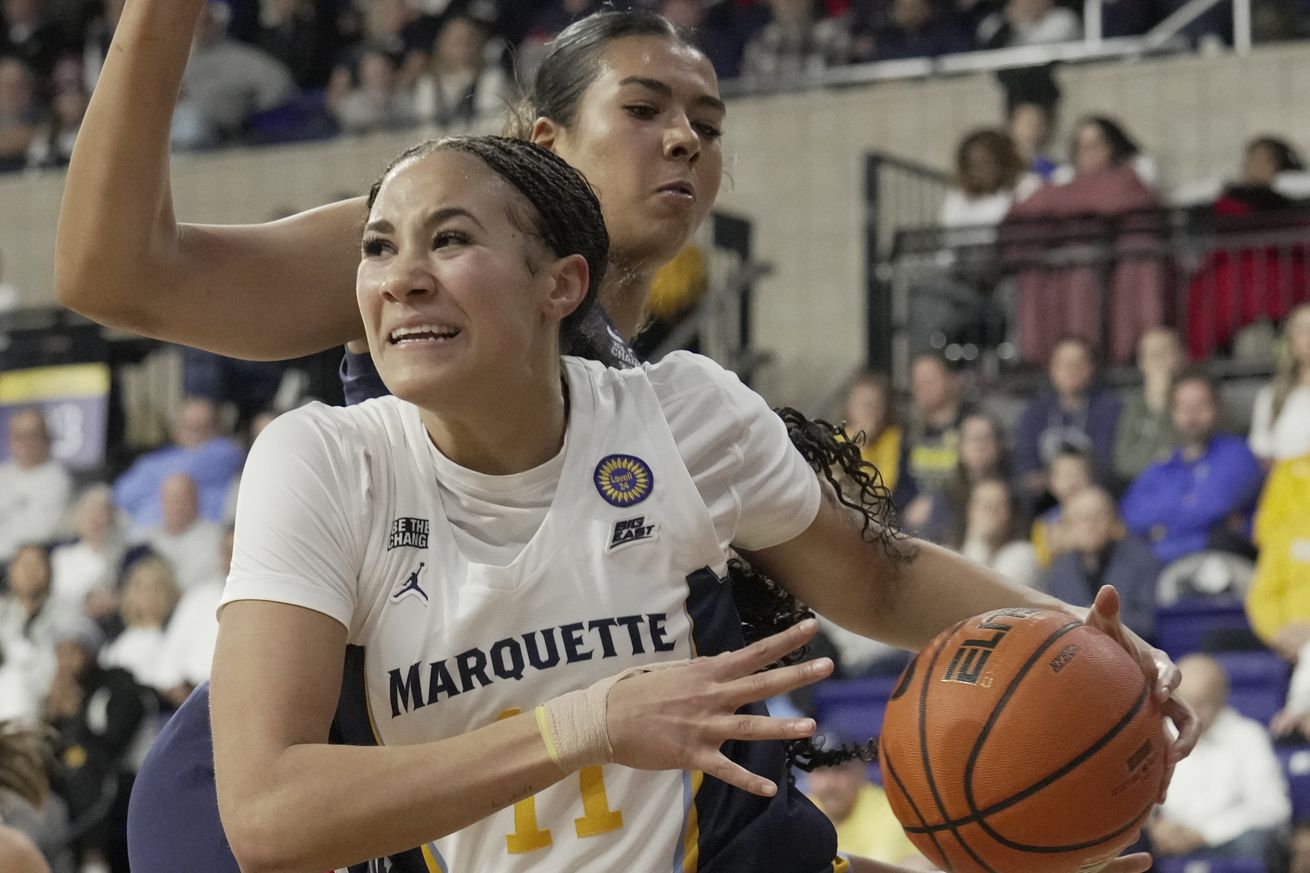 Marquette forward Skylar Forbes (11) droves around Connecticut center Jana El Alfy (8) during the second half of their game Wednesday, January 1, 2025 at the Al McGuire Center in Milwaukee, Wisconsin. Connecticut beat Marquette 77-45.