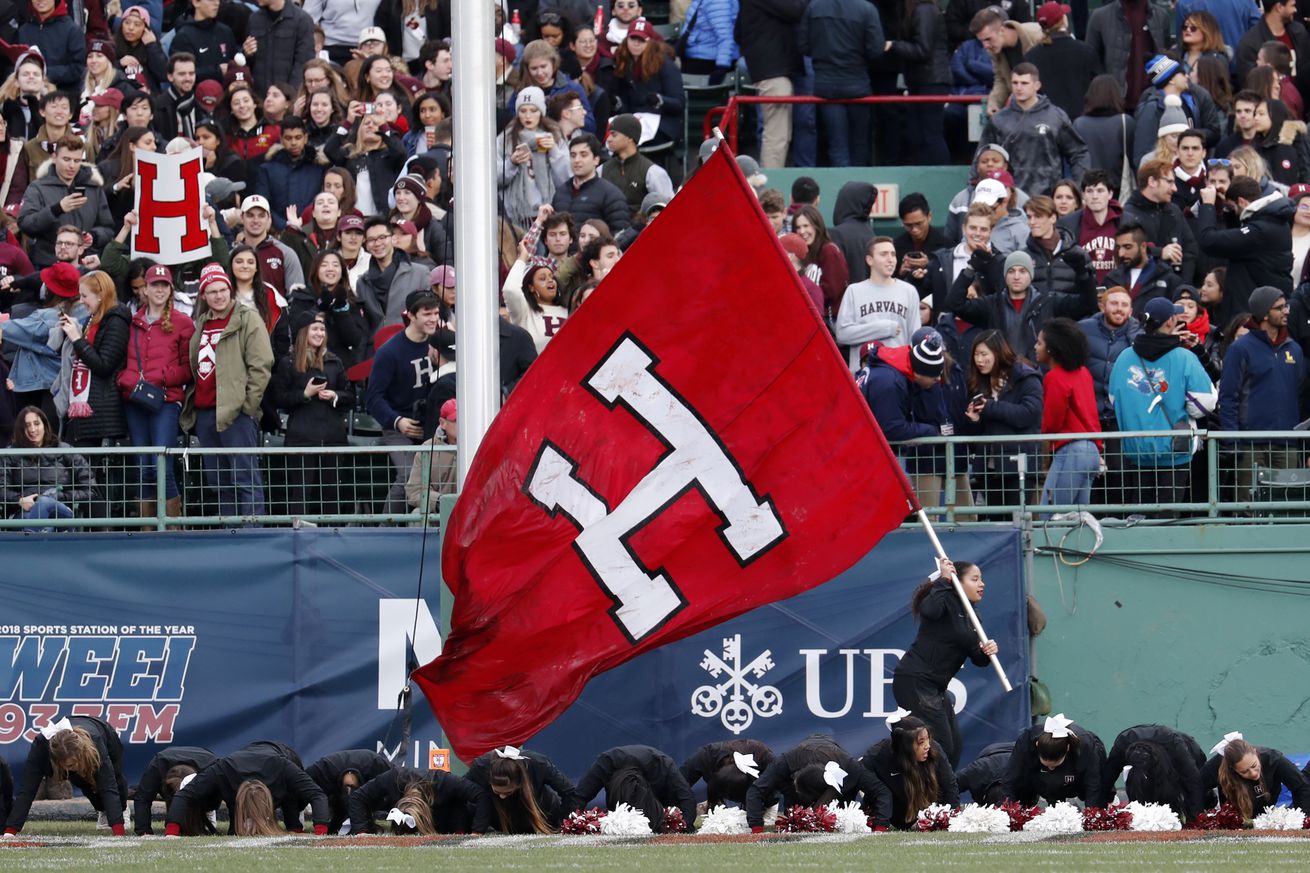 The Harvard flag is run through the end zone after a touchdown during the 135th playing of The Game between the Harvard University Crimson and the Yale University Bulldogs on November 17, 2018 at Fenway Park in Boston, Massachusetts.