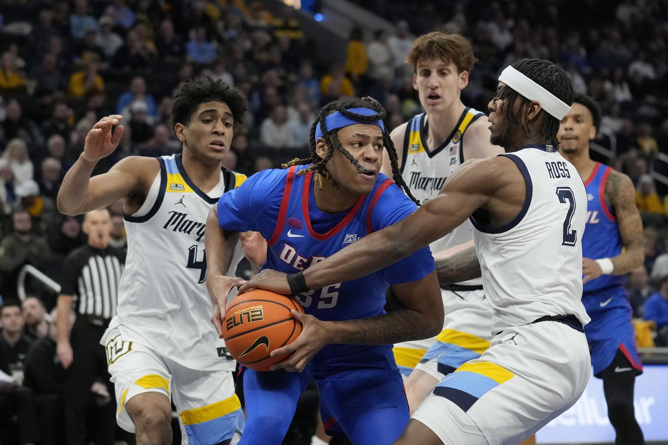 Chase Ross #2 of the Marquette Golden Eagles defends NJ Benson #35 of the DePaul Blue Demons during the second half at Fiserv Forum on February 11, 2025 in Milwaukee, Wisconsin.