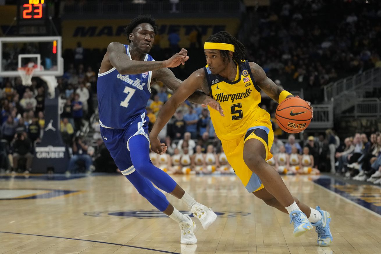 Tre Norman #5 of the Marquette Golden Eagles dribbles the ball against Scotty Middleton #7 of the Seton Hall Pirates during the first half at Fiserv Forum on February 18, 2025 in Milwaukee, Wisconsin.