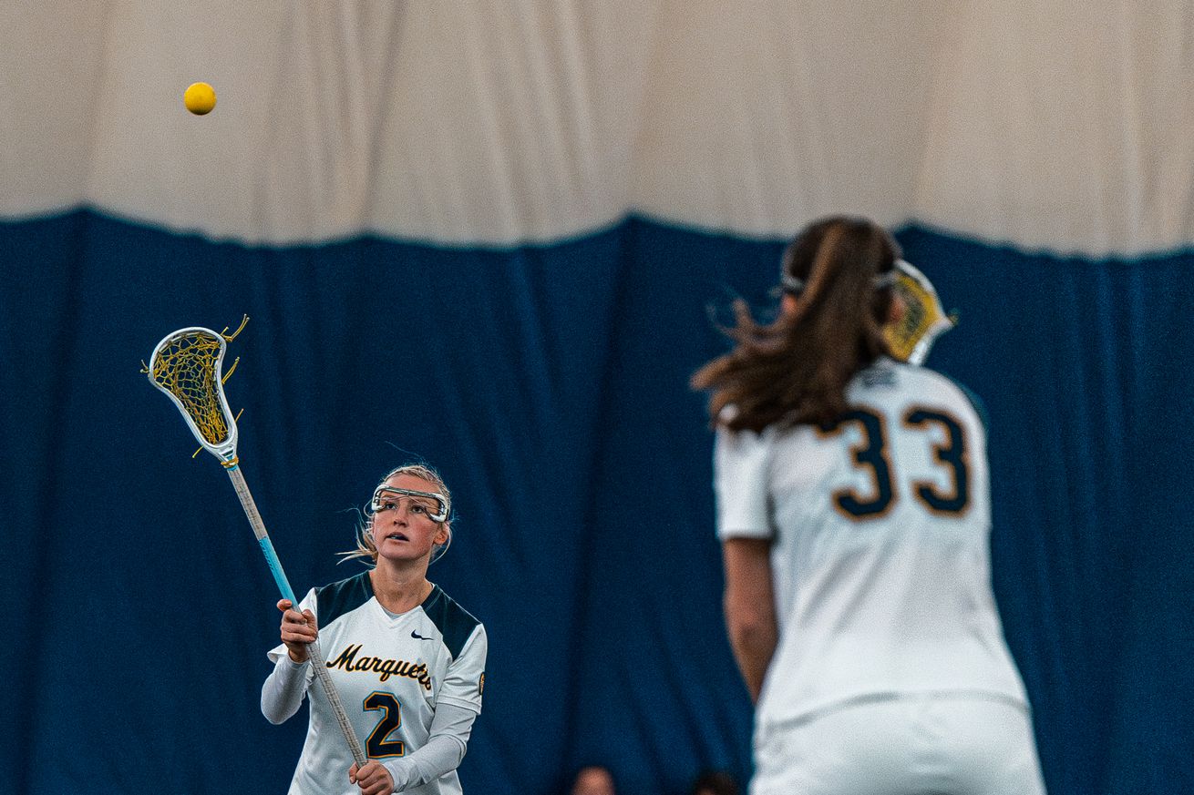 Marquette’s Hanna Bodner and Meg Bireley pass the ball during a game in the Marquette seasonal bubble.