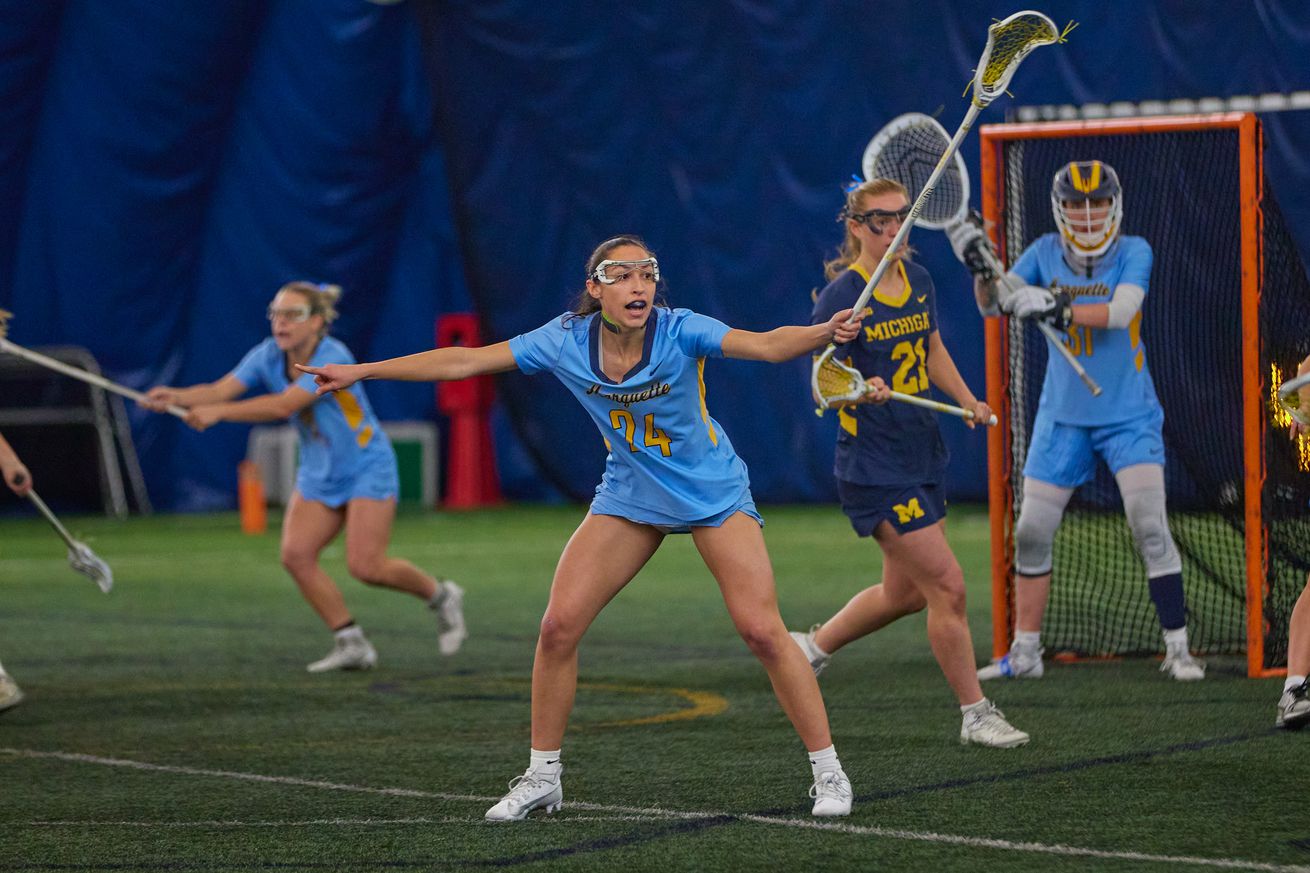 Marquette defender Sofia Santana calls out defensive adjustments in a home game against Michigan. Goalie Brynna Nixon minds the net in the background.