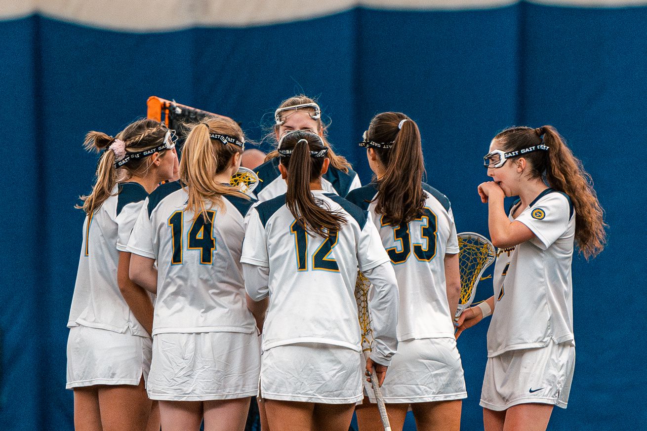 Marquette women’s lacrosse huddles up during a scrimmage against University of Chicago in the Valley Fields seasonal bubble.