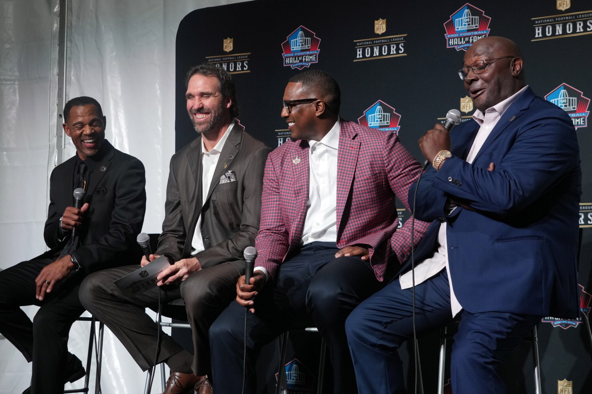 Eric Allen, Jared Allen, Antonio Gates and Sterling Sharpe react during the Pro Football Hall of Fame Class of 2025 press conference at the Saenger Theater.