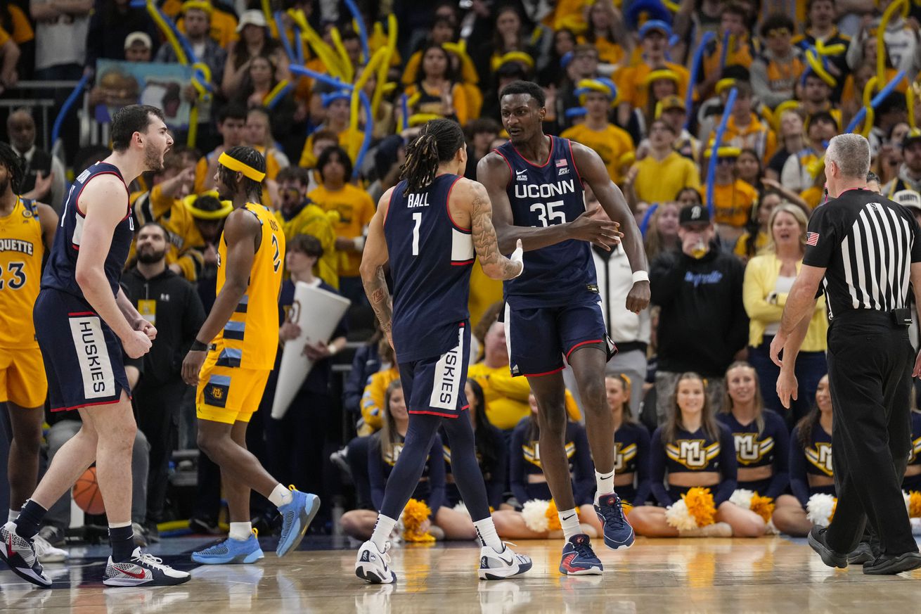 Connecticut Huskies center Samson Johnson (35) celebrates with guard Solo Ball (1) following a play during the second half against the Marquette Golden Eagles at Fiserv Forum.