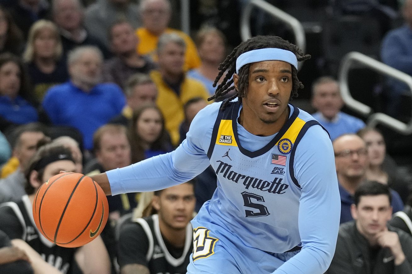 Tre Norman #5 of the Marquette Golden Eagles dribbles the ball against the Providence Friars during the first half at Fiserv Forum on February 25, 2025 in Milwaukee, Wisconsin.