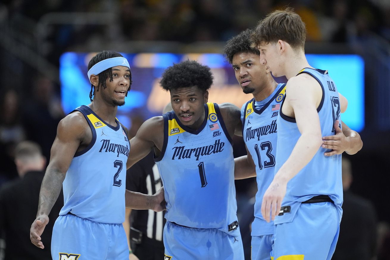 Chase Ross #2, Kam Jones #1, Royce Parham #13 and Ben Gold #12 of the Marquette Golden Eagles talk during the first half against the St. John’s Red Storm at Fiserv Forum on March 08, 2025 in Milwaukee, Wisconsin.