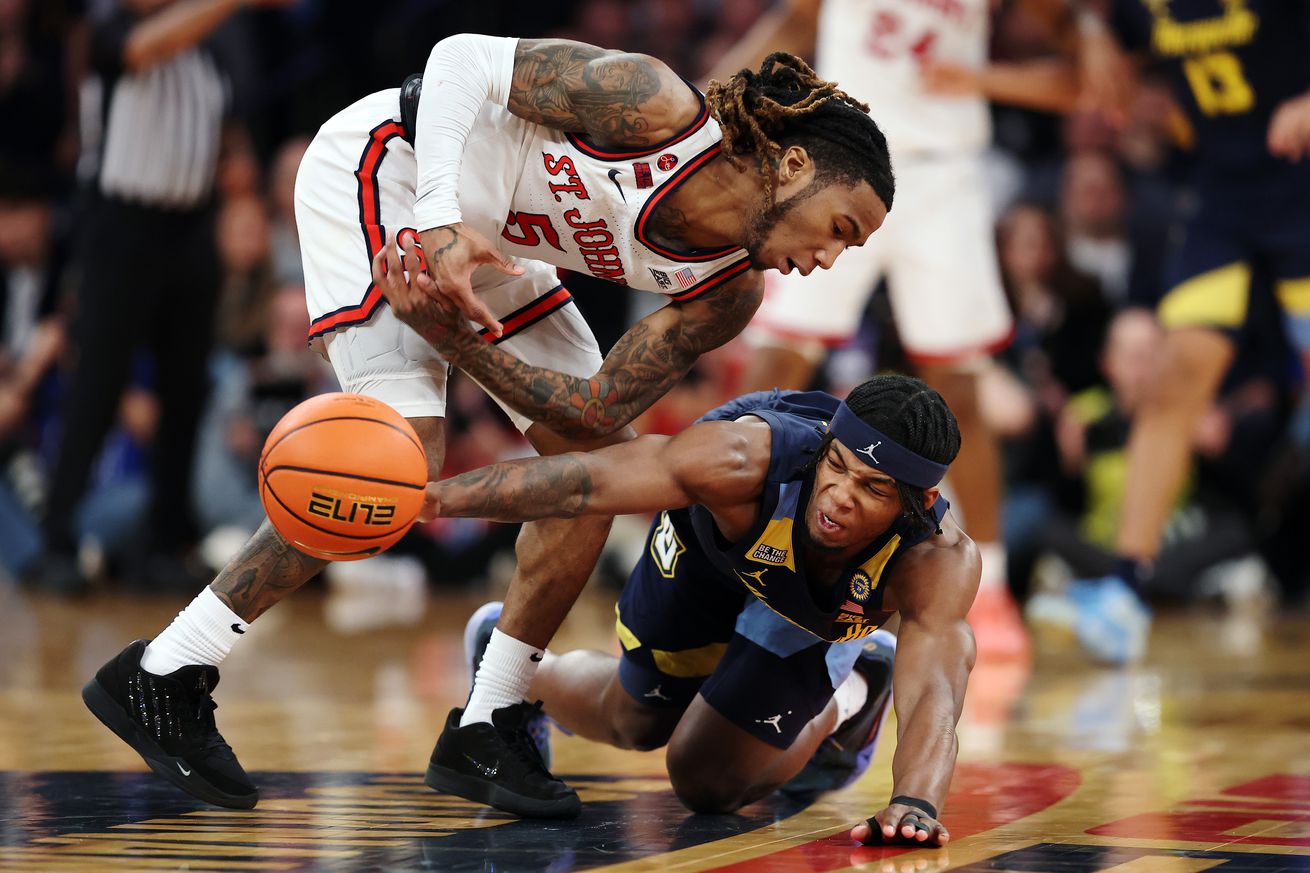 Chase Ross #2 of the Marquette Golden Eagles battles Deivon Smith #5 of the St. John’s Red Storm for a loose ball in the first half of a semifinal game during the Big East Men’s Basketball Tournament at Madison Square Garden on March 14, 2025 in New York City.