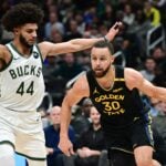 Golden State Warriors guard Stephen Curry (30) defended by Milwaukee Bucks wing Andre Jackson Jr. (44)