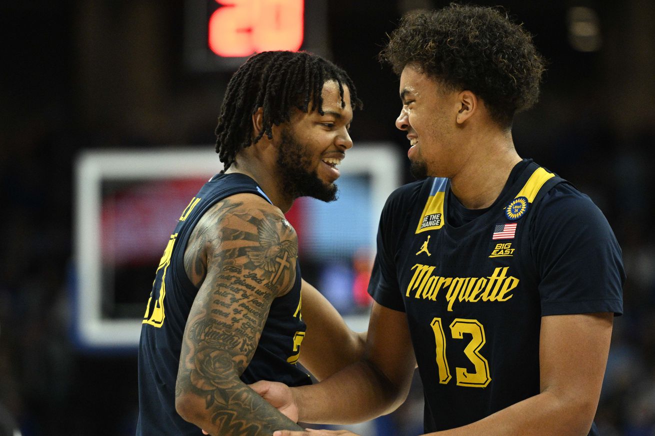 Marquette Golden Eagles forward David Joplin (23) and forward Royce Parham (13) share a moment during the game against the Creighton Bluejays in the second half at CHI Health Center Omaha.