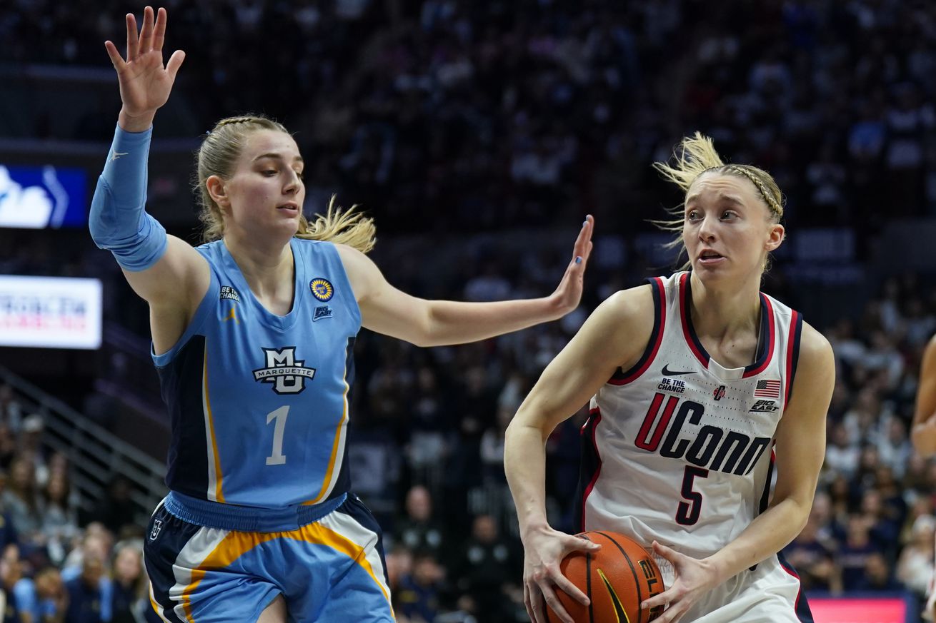 UConn Huskies guard Paige Bueckers (5) looks for an opening past Marquette Golden Eagles guard Lee Volker (1) in the second half at Harry A. Gampel Pavilion.