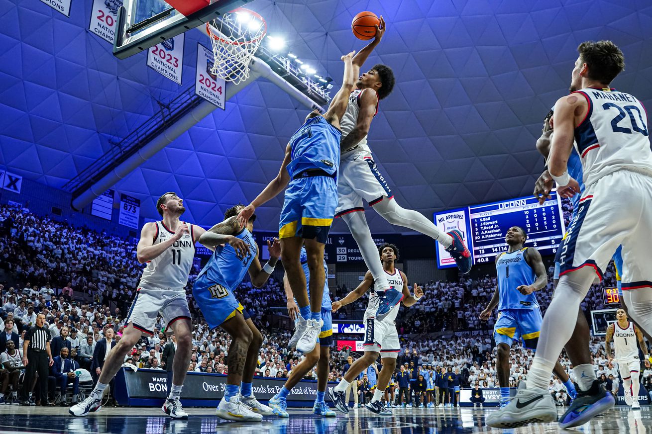 UConn Huskies forward Jaylin Stewart (3) makes the put-back basket against Marquette Golden Eagles guard Stevie Mitchell (4) in the second half at Harry A. Gampel Pavilion. 